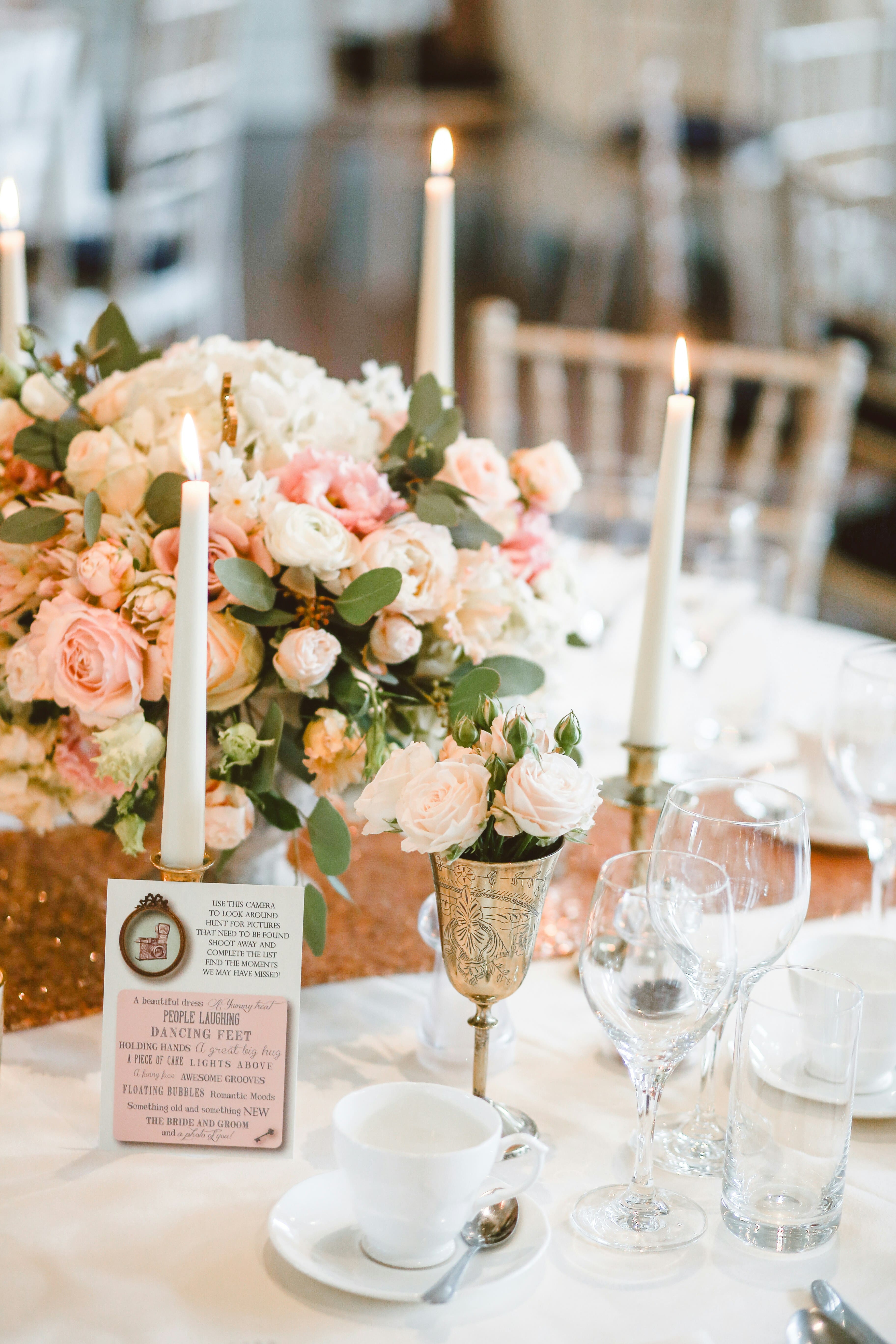 Image of some flowers and drinking glass on top of a weddings eating table